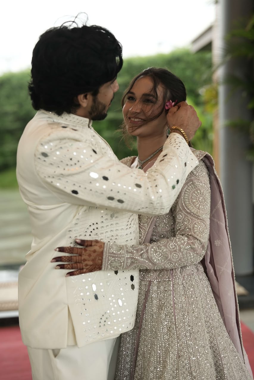 Sparsh tucking a flower into Shanya's hair